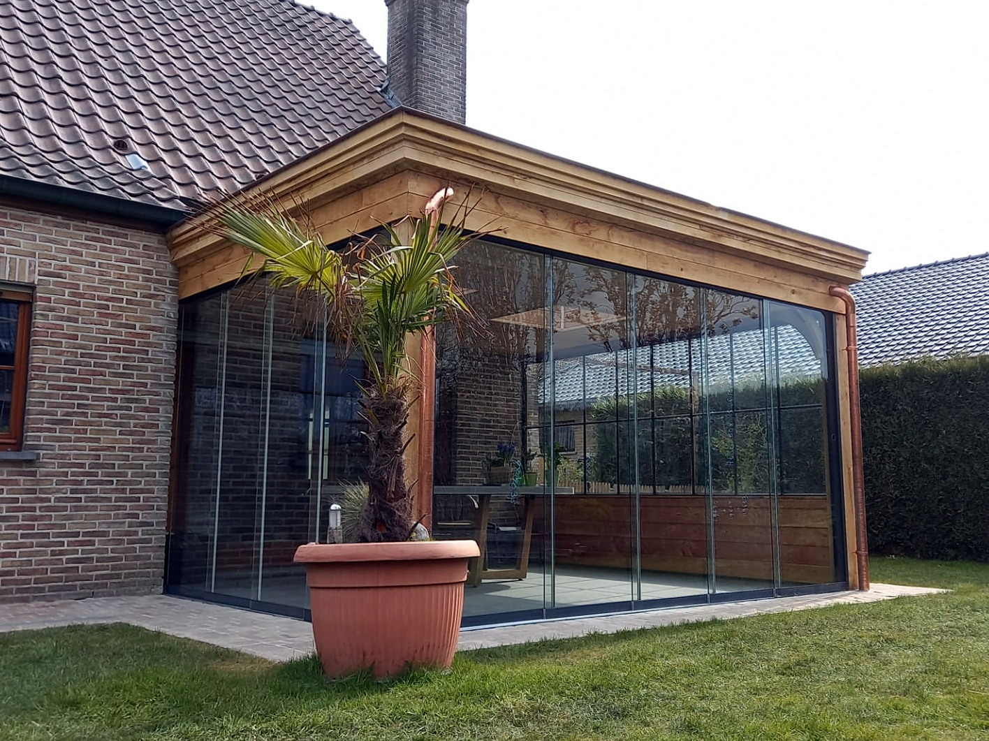 Landelijke terrasoverkapping aan huis ingericht als veranda voor klant regio Sleidinge
